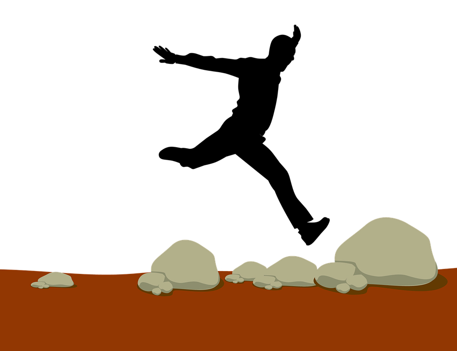 Silhouette man jumping from rock to rock